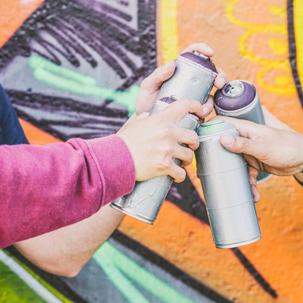 close-up-hands-of-people-holding-color-spray-ca.jpg